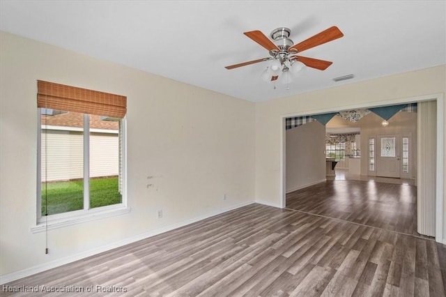 empty room with hardwood / wood-style floors and ceiling fan