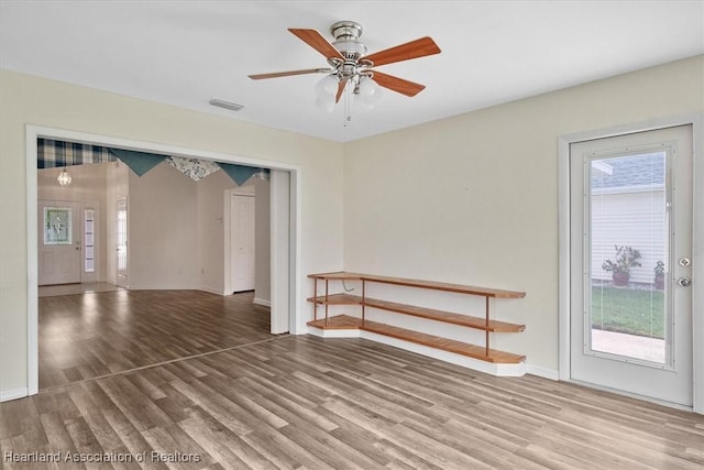 unfurnished room featuring hardwood / wood-style floors, plenty of natural light, and ceiling fan