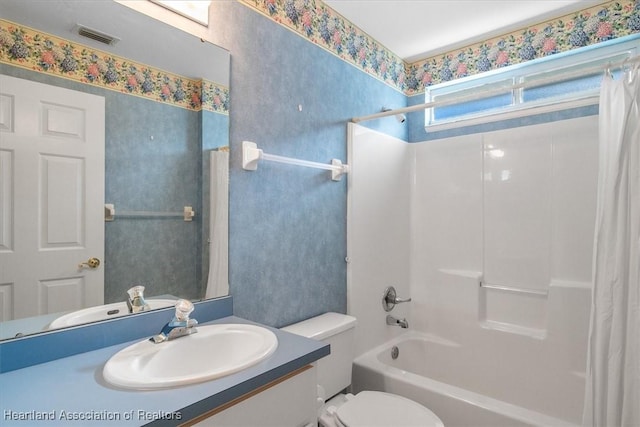 full bathroom with shower / bath combination with curtain, toilet, and vanity