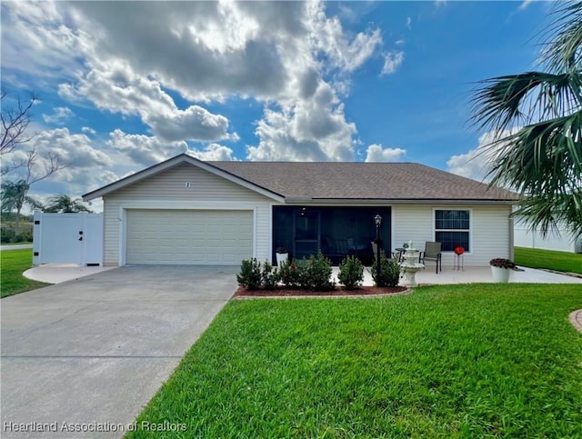 single story home with driveway, a front lawn, a patio, and an attached garage