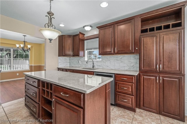 kitchen featuring decorative backsplash, decorative light fixtures, a notable chandelier, dishwasher, and a center island