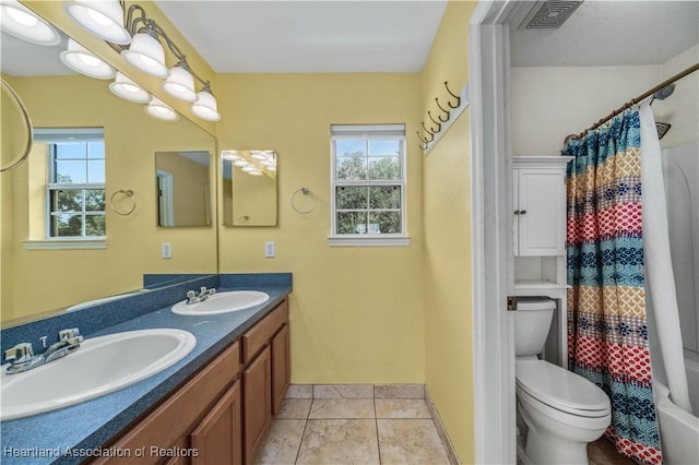 full bathroom with tile patterned floors, vanity, toilet, and shower / tub combo with curtain