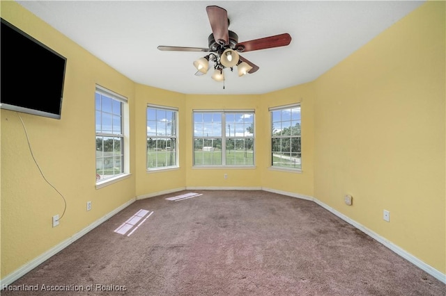 spare room with light carpet and ceiling fan