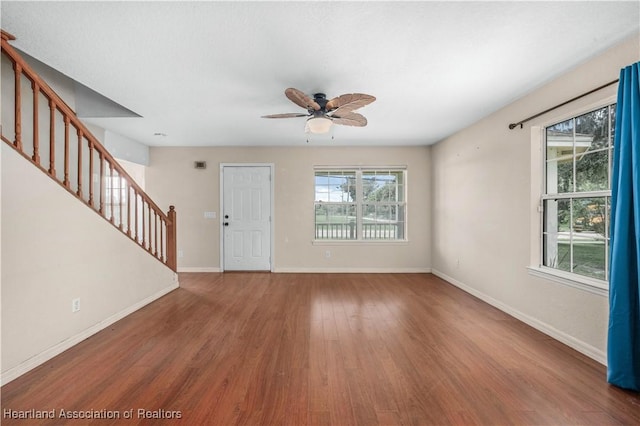 unfurnished living room featuring hardwood / wood-style floors and ceiling fan