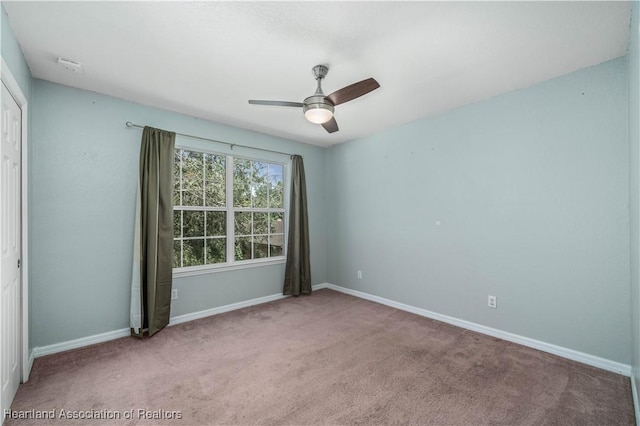 carpeted empty room with ceiling fan