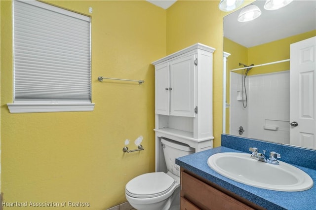 bathroom featuring walk in shower, vanity, and toilet