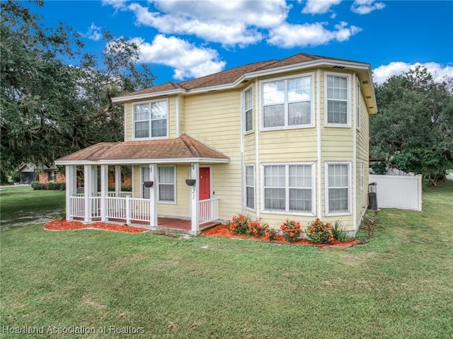 view of front facade with covered porch and a front yard