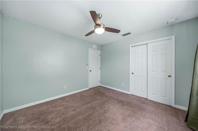 unfurnished bedroom with carpet flooring, ceiling fan, and a closet