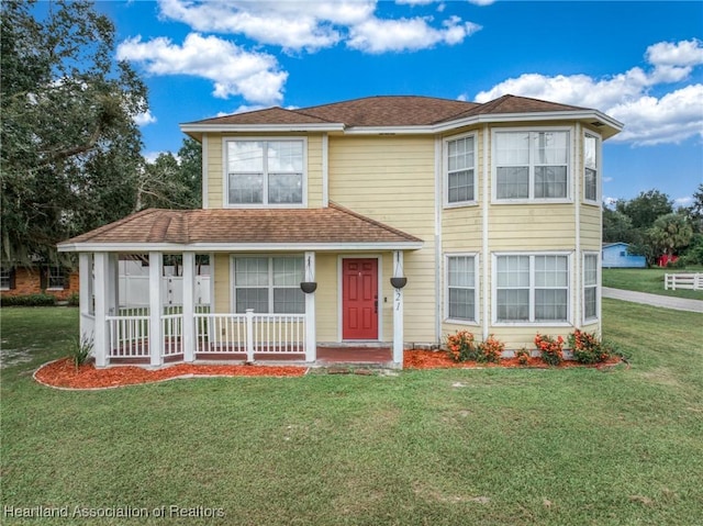 view of front of property featuring a front lawn and covered porch