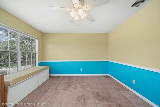 carpeted empty room featuring ceiling fan