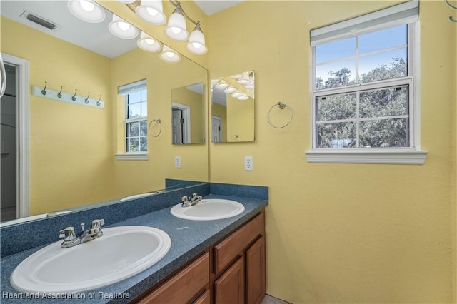 bathroom with plenty of natural light and vanity