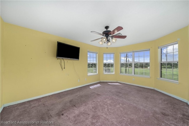 empty room featuring carpet flooring and ceiling fan