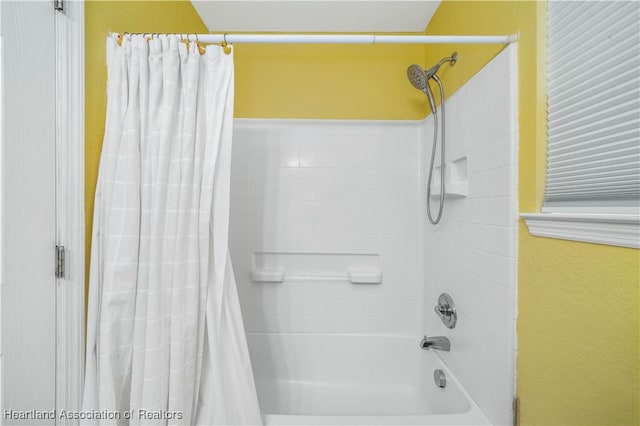 bathroom with shower / tub combo with curtain