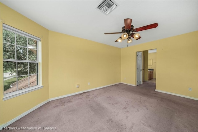 carpeted empty room featuring ceiling fan