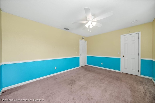 unfurnished room featuring ceiling fan and carpet floors