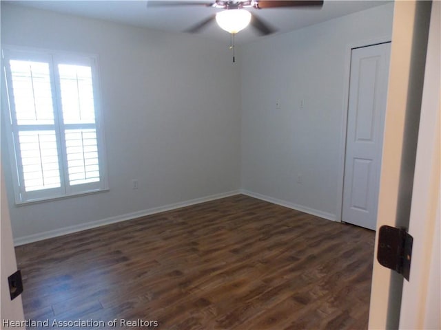 unfurnished room featuring dark wood-type flooring, ceiling fan, and a healthy amount of sunlight