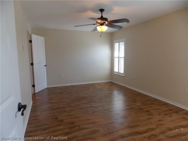 empty room featuring ceiling fan and dark wood-type flooring