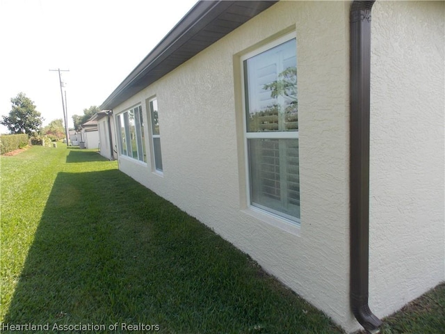 view of side of home featuring a lawn