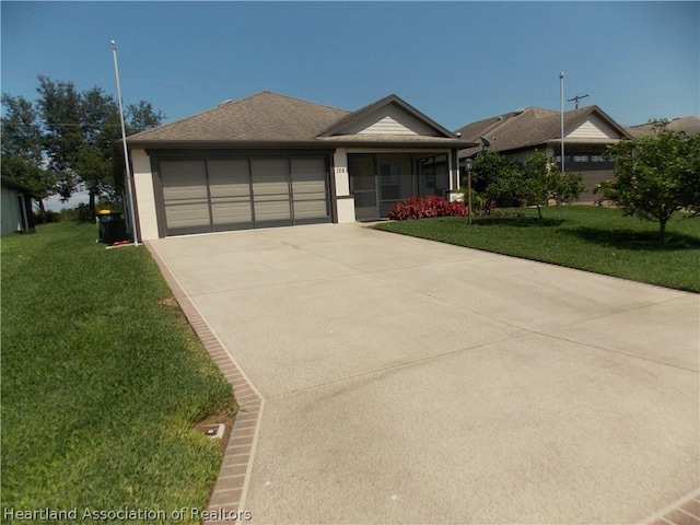 view of front of property with a garage and a front lawn