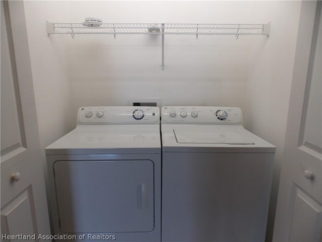 clothes washing area featuring washer and dryer