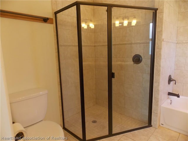 bathroom with tile patterned flooring, toilet, and independent shower and bath