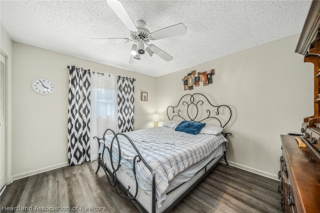 bedroom with ceiling fan, dark hardwood / wood-style floors, and a textured ceiling