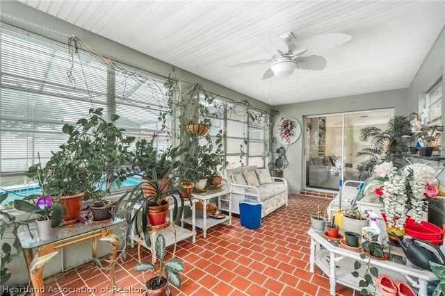 sunroom / solarium featuring ceiling fan