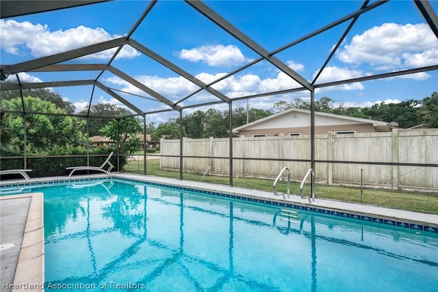 view of pool with glass enclosure