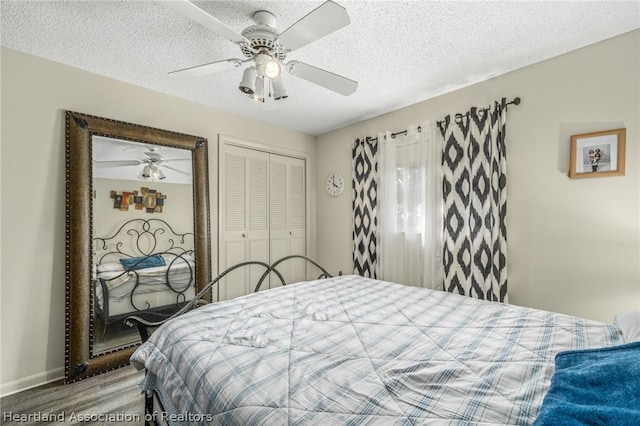 bedroom featuring hardwood / wood-style floors, a textured ceiling, a closet, and ceiling fan