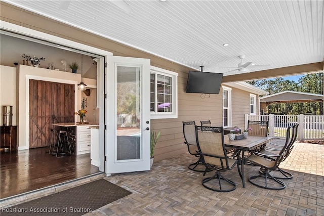 5931 Fig Rd, Sebring, FL 33875 - view of patio with a ceiling fan, outdoor dining area, and fence