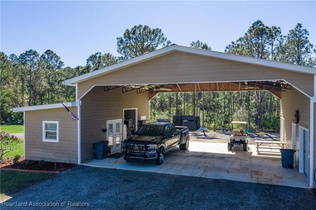 5931 Fig Rd, Sebring, FL 33875 - view of vehicle parking featuring french doors, aphalt driveway, and an attached carport