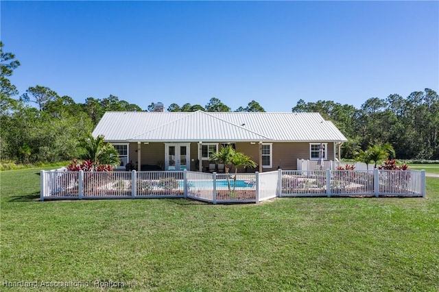 5931 Fig Rd, Sebring, FL 33875 - back of house with a lawn, a patio area, a fenced in pool, and metal roof