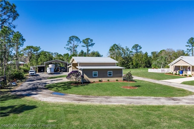 5931 Fig Rd, Sebring, FL 33875 - view of front of home featuring a detached carport, driveway, a front yard, and metal roof