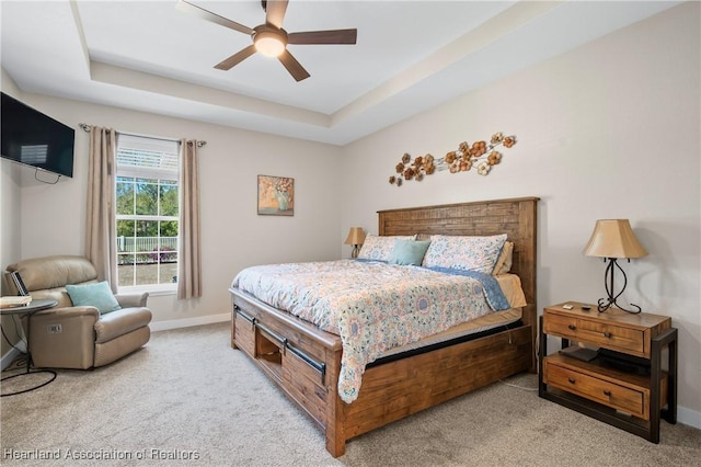 5931 Fig Rd, Sebring, FL 33875 - bedroom featuring carpet floors, a ceiling fan, a tray ceiling, and baseboards