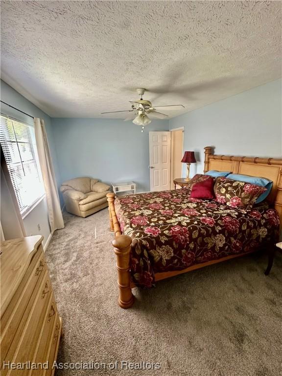 302 Whatley Blvd, Sebring, FL 33870 - carpeted bedroom featuring a textured ceiling and ceiling fan