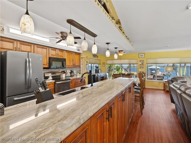 123 Harry Lee Rd, Lake Placid, FL 33852 - kitchen featuring decorative light fixtures, light stone countertops, ceiling fan, and appliances with stainless steel finishes