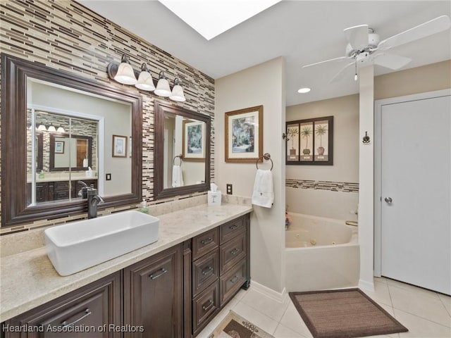 123 Harry Lee Rd, Lake Placid, FL 33852 - bathroom with tile patterned floors, a skylight, vanity, a bath, and ceiling fan