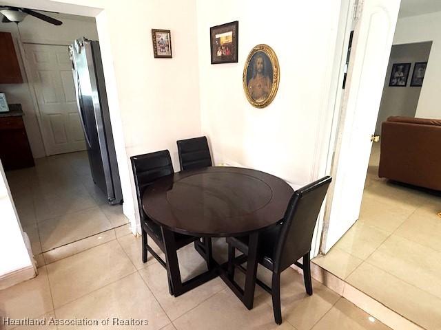 tiled dining room featuring ceiling fan