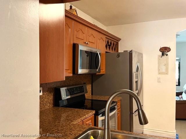 kitchen with sink, decorative backsplash, and appliances with stainless steel finishes