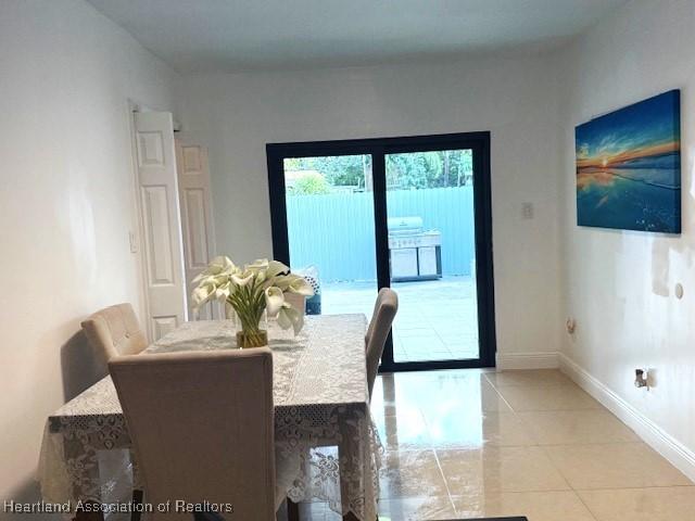 dining room with light tile patterned flooring