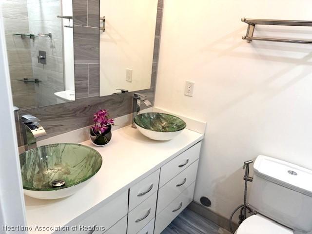 bathroom featuring vanity and toilet