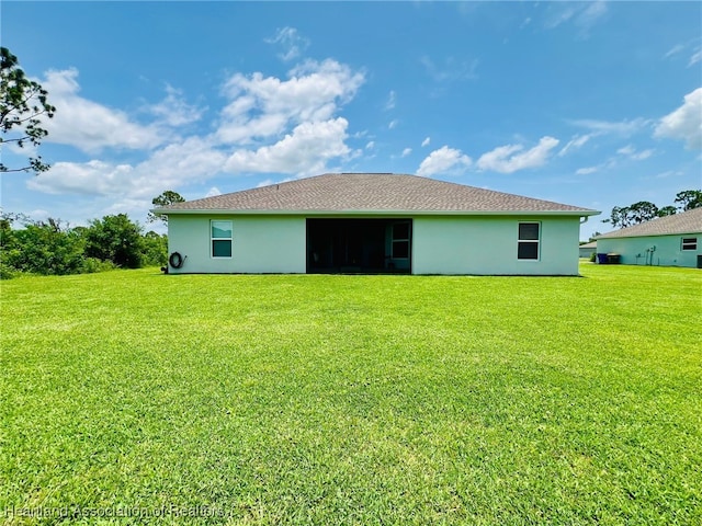 5310 Pebble Dr, Sebring, FL 33872 - rear view of property with stucco siding and a yard