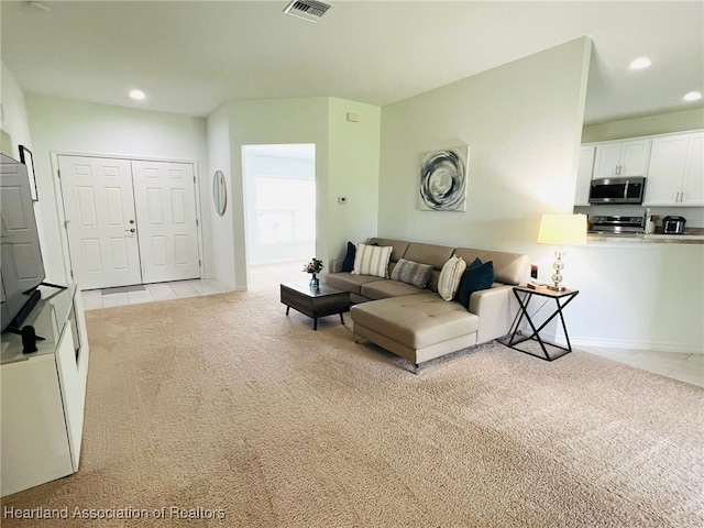 5310 Pebble Dr, Sebring, FL 33872 - living area with light colored carpet, recessed lighting, and light tile patterned floors