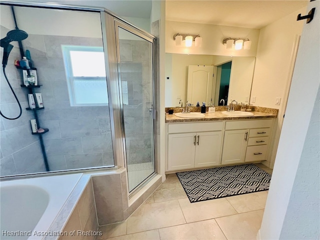 5310 Pebble Dr, Sebring, FL 33872 - full bathroom featuring a shower stall, double vanity, a garden tub, and tile patterned flooring