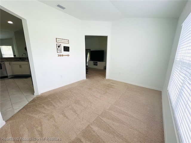 5310 Pebble Dr, Sebring, FL 33872 - empty room with light colored carpet and vaulted ceiling