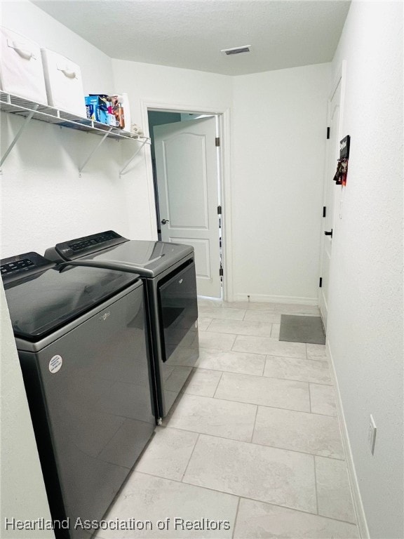 5310 Pebble Dr, Sebring, FL 33872 - laundry area featuring separate washer and dryer and baseboards