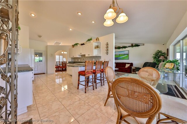 dining area featuring light wood-style flooring and baseboards