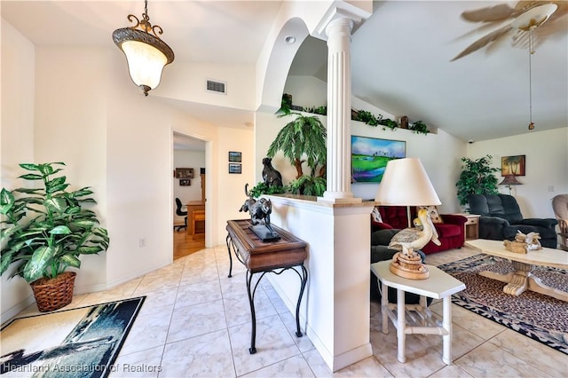 living area with decorative columns, a ceiling fan, lofted ceiling, and visible vents