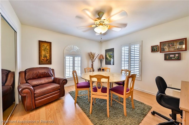 dining room with a ceiling fan, light wood-style flooring, and baseboards