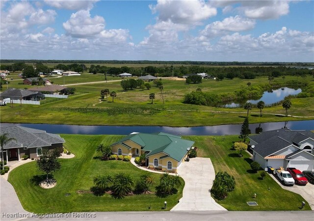 ranch-style home with metal roof, concrete driveway, and stucco siding